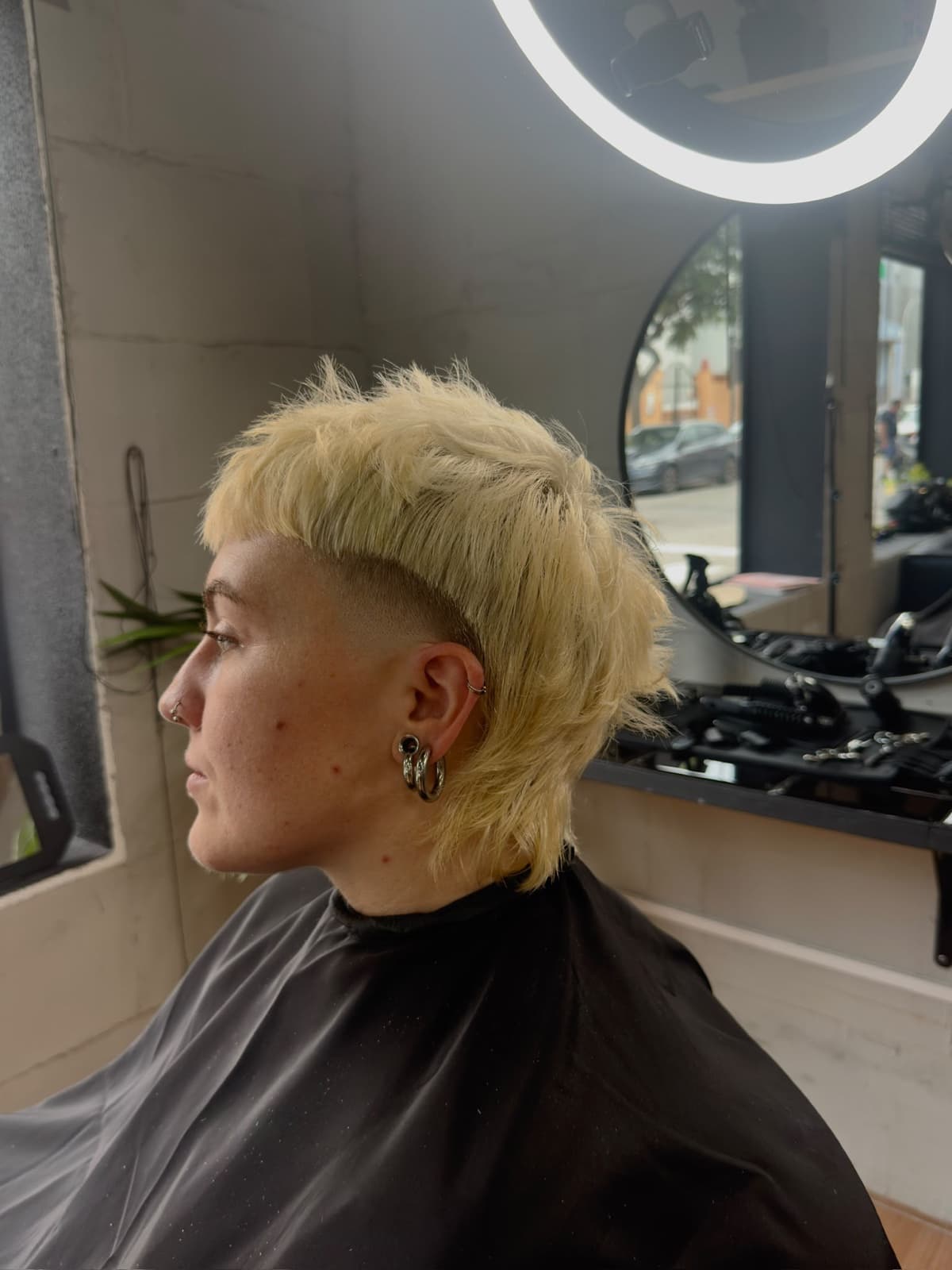 Platinum blonde mullet with a side fade, in the studio chair
